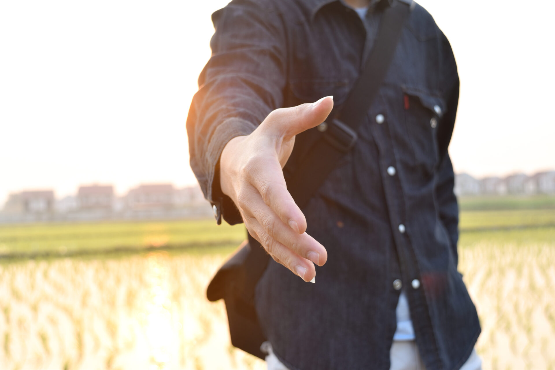 man holding out hand against ablurred background