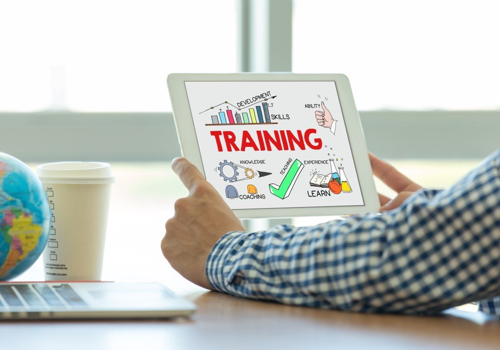 man reading a tablet with training written on it