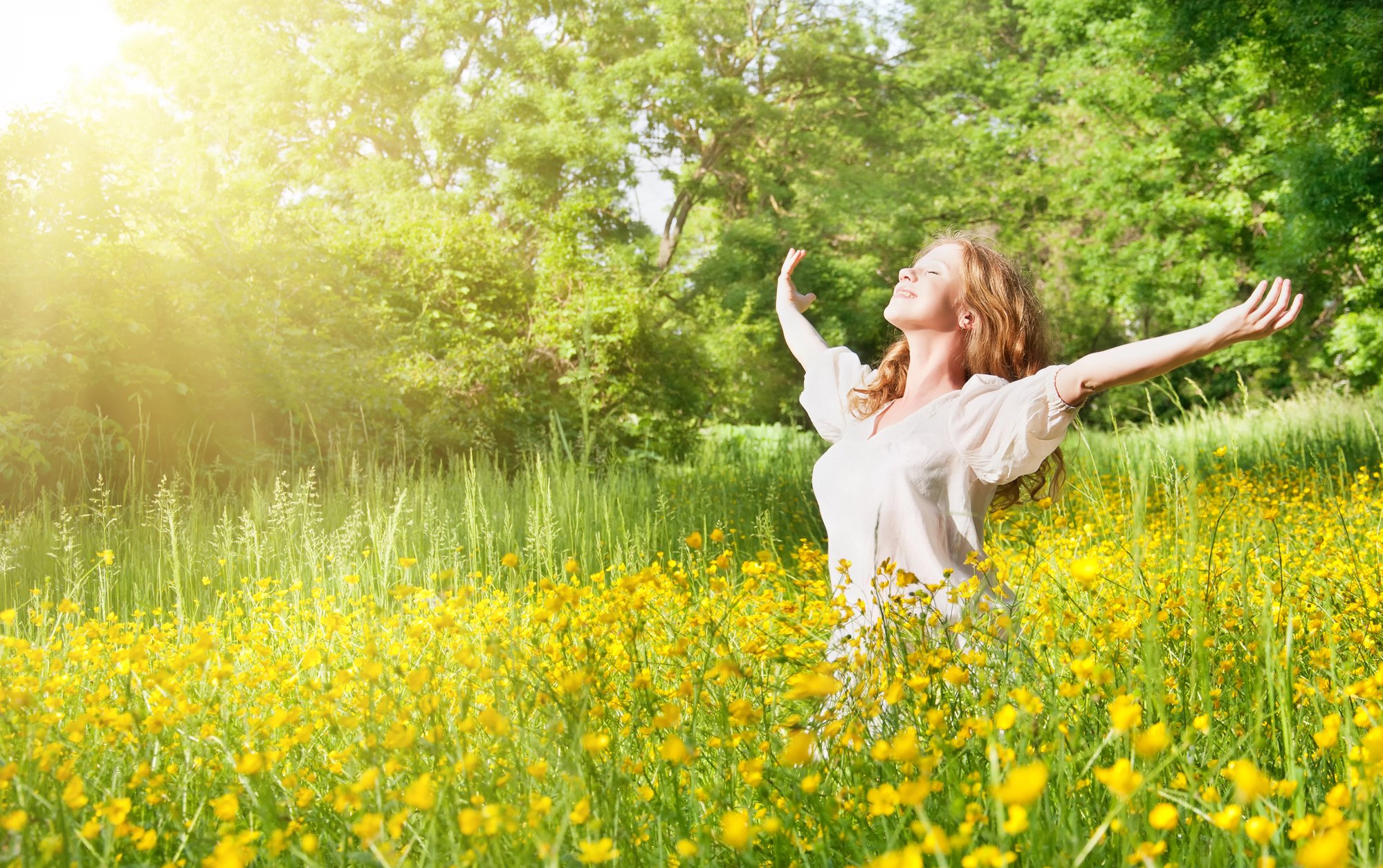 Woman in field enjoying sunshine
