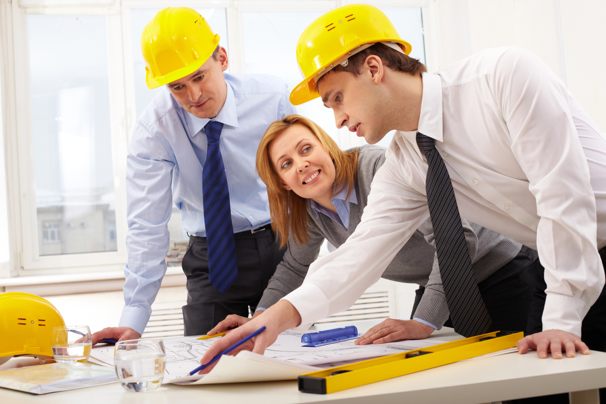 Depositphotos_11632444_L two engineers and a woman leader discussing plans